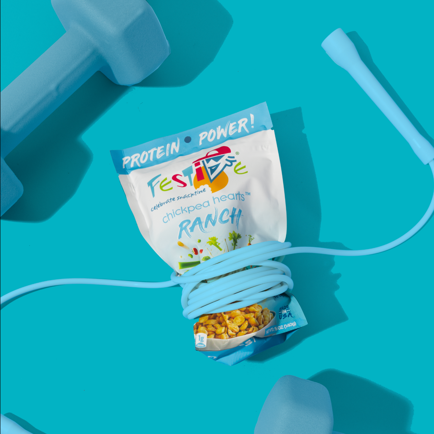 Festive protein snack package with a jump rope and dumbbells on a blue background