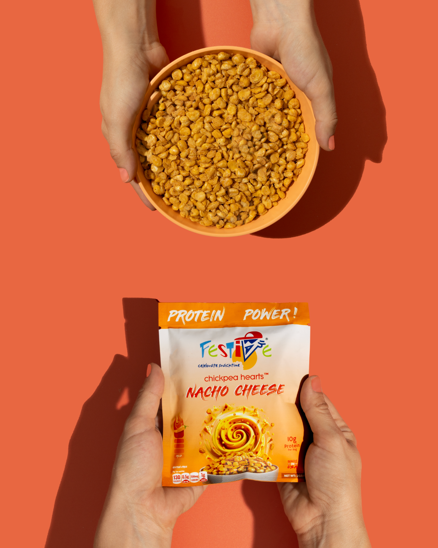 Person holding a bowl of festive chickpeas and a package of nacho festive chickpeas on an orange background