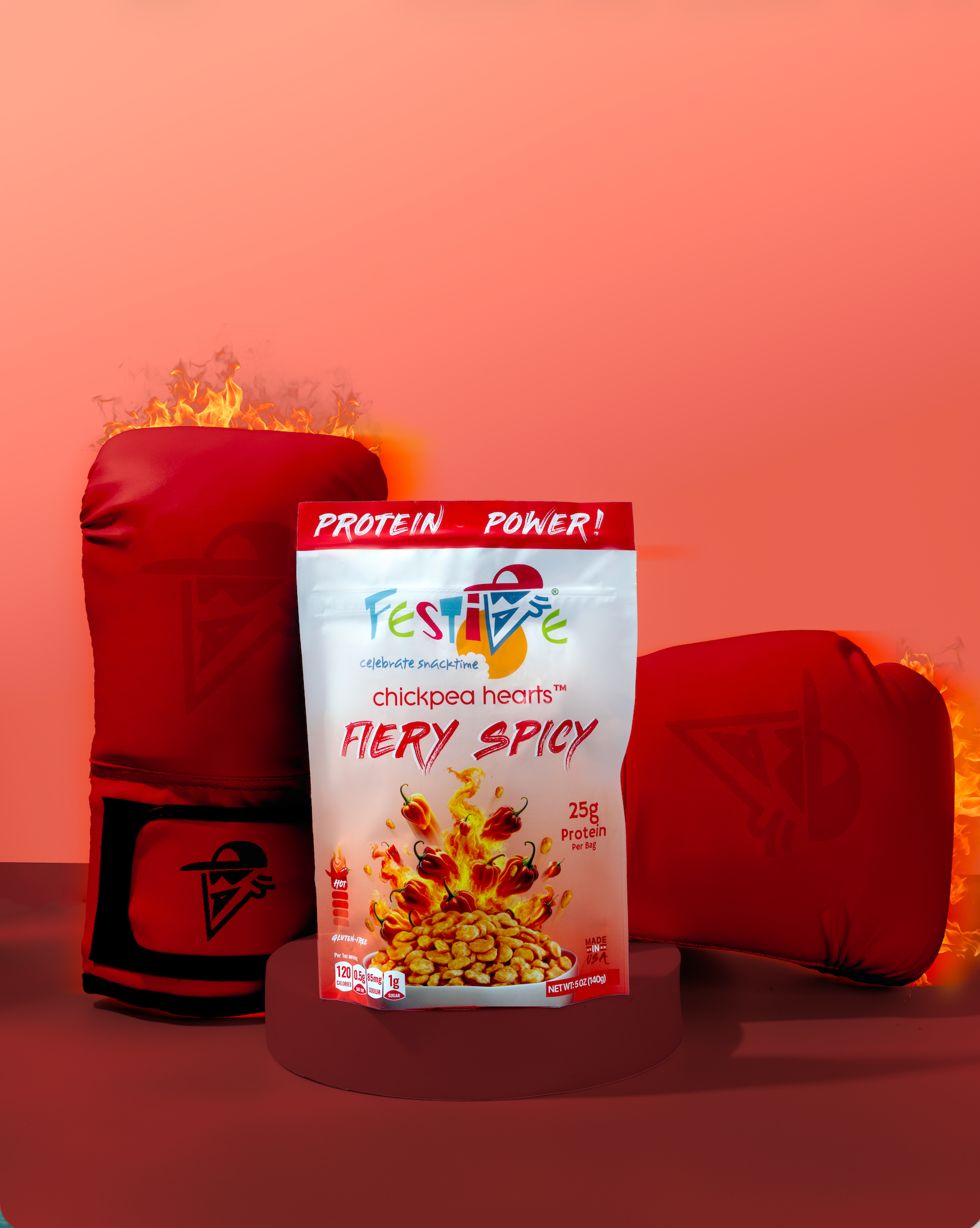 Festive protein snack package with fiery spicy flavor in front of red boxing gloves on a peach background